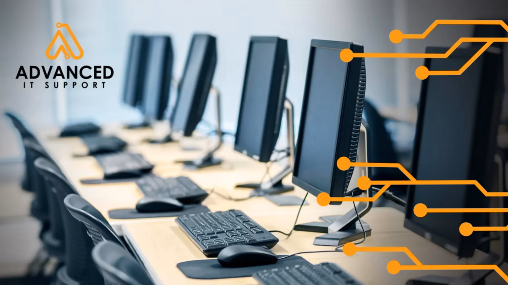 Photo of multiple computers lined up with Advanced IT Support branding and orange design elements, used in IT support blog post