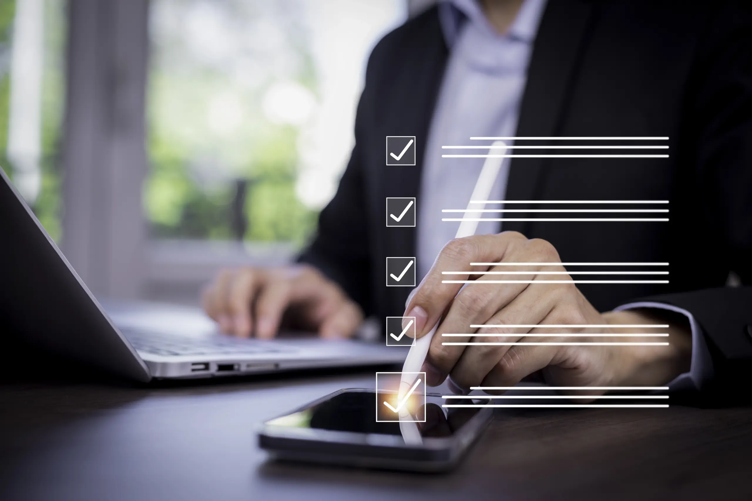 Office manager reviewing an employee offboarding checklist on a laptop