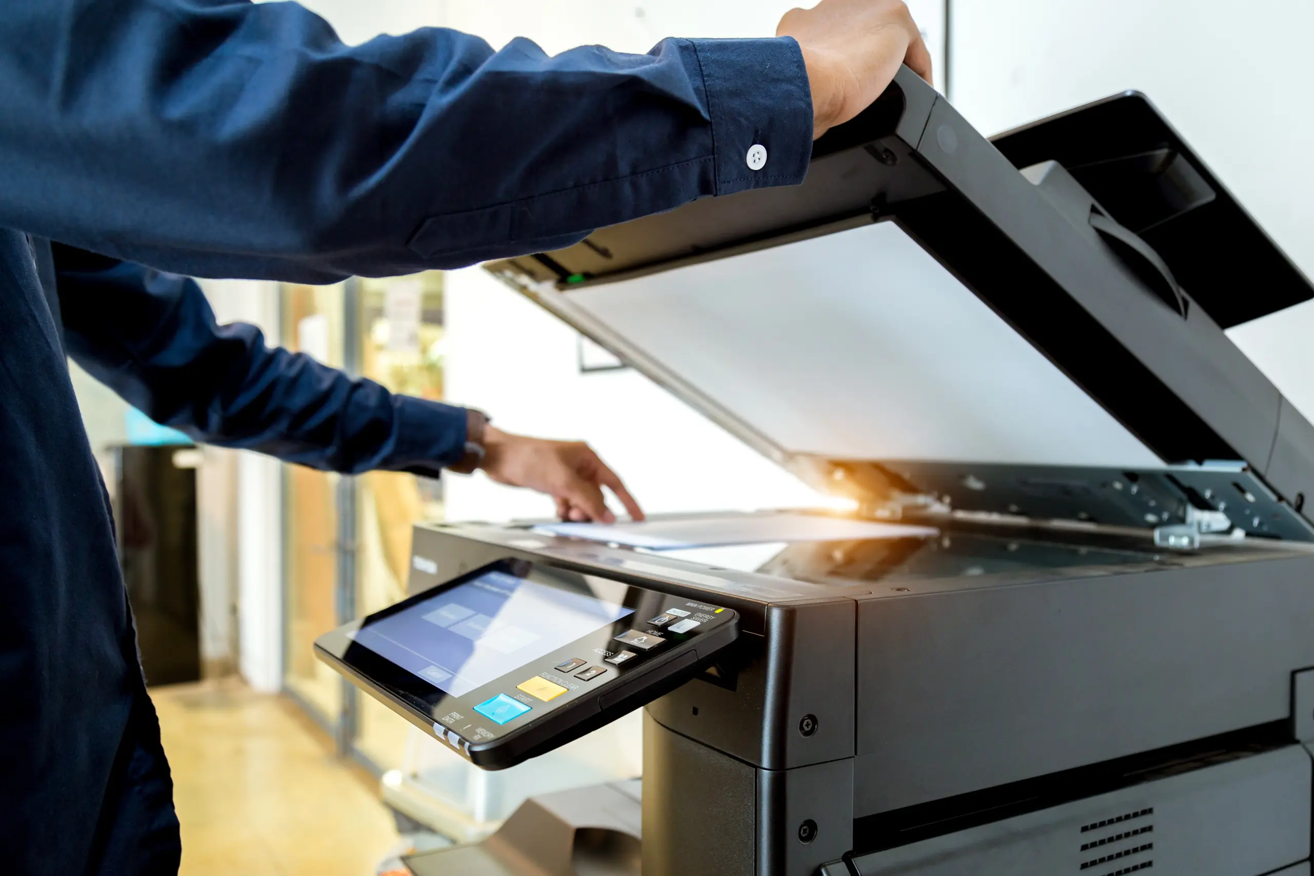 Office copier next to a server rack, representing print versus IT services